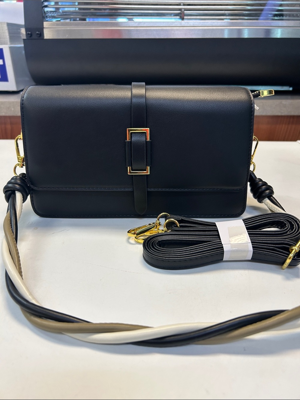 Sleek Black Crossbody Bag with Gold Buckle Detail